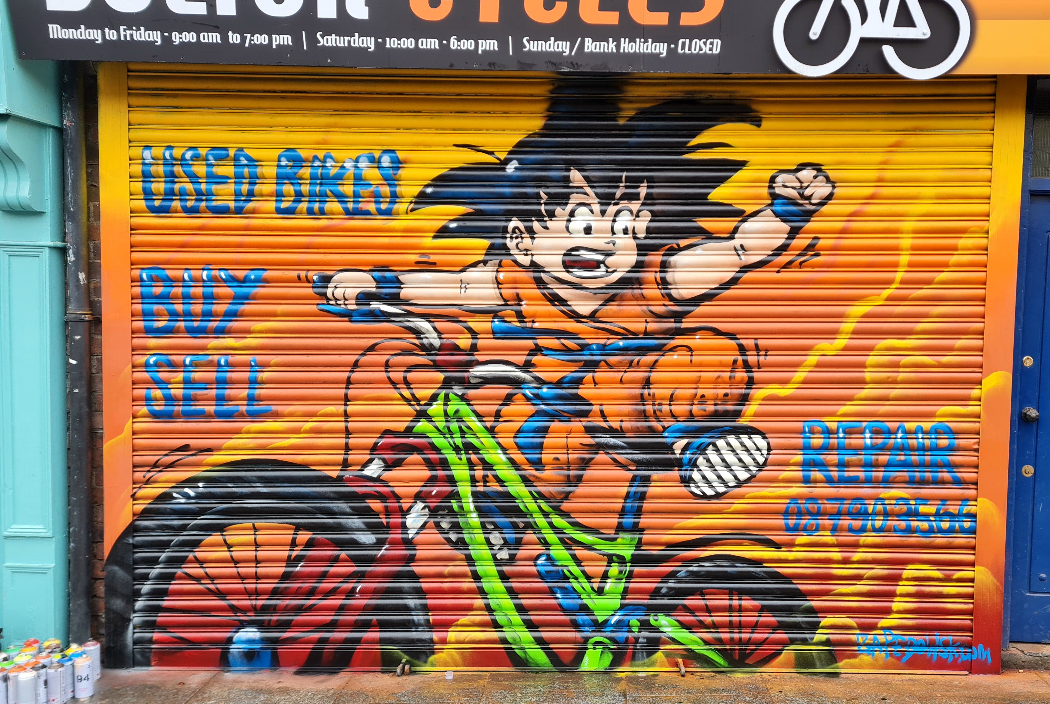 Custom bicycle-themed mural painted on a Dublin bike shop exterior by ZAP Art mural artist
