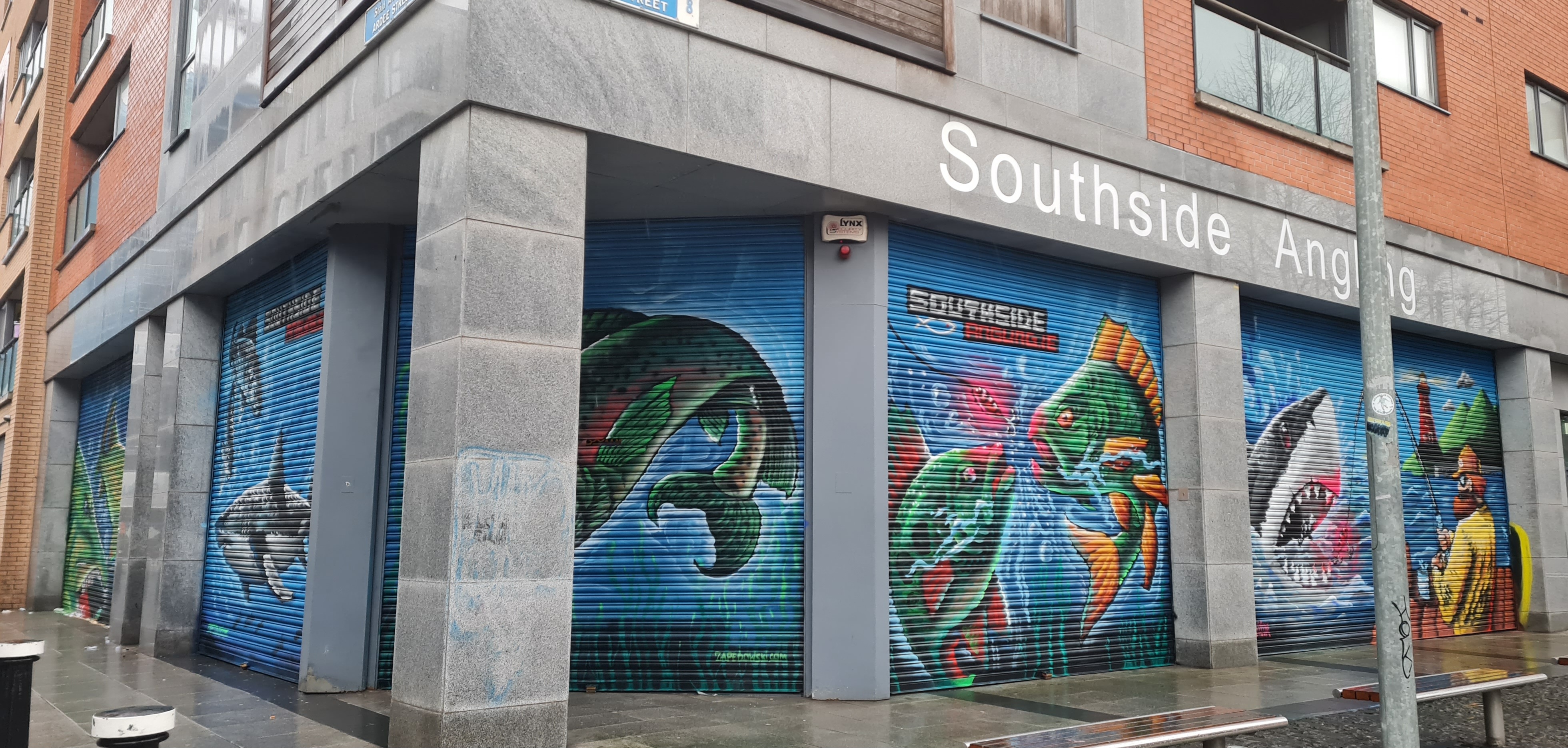 Eye-catching fishing-themed commercial mural painted on a Dublin storefront by ZAP Art