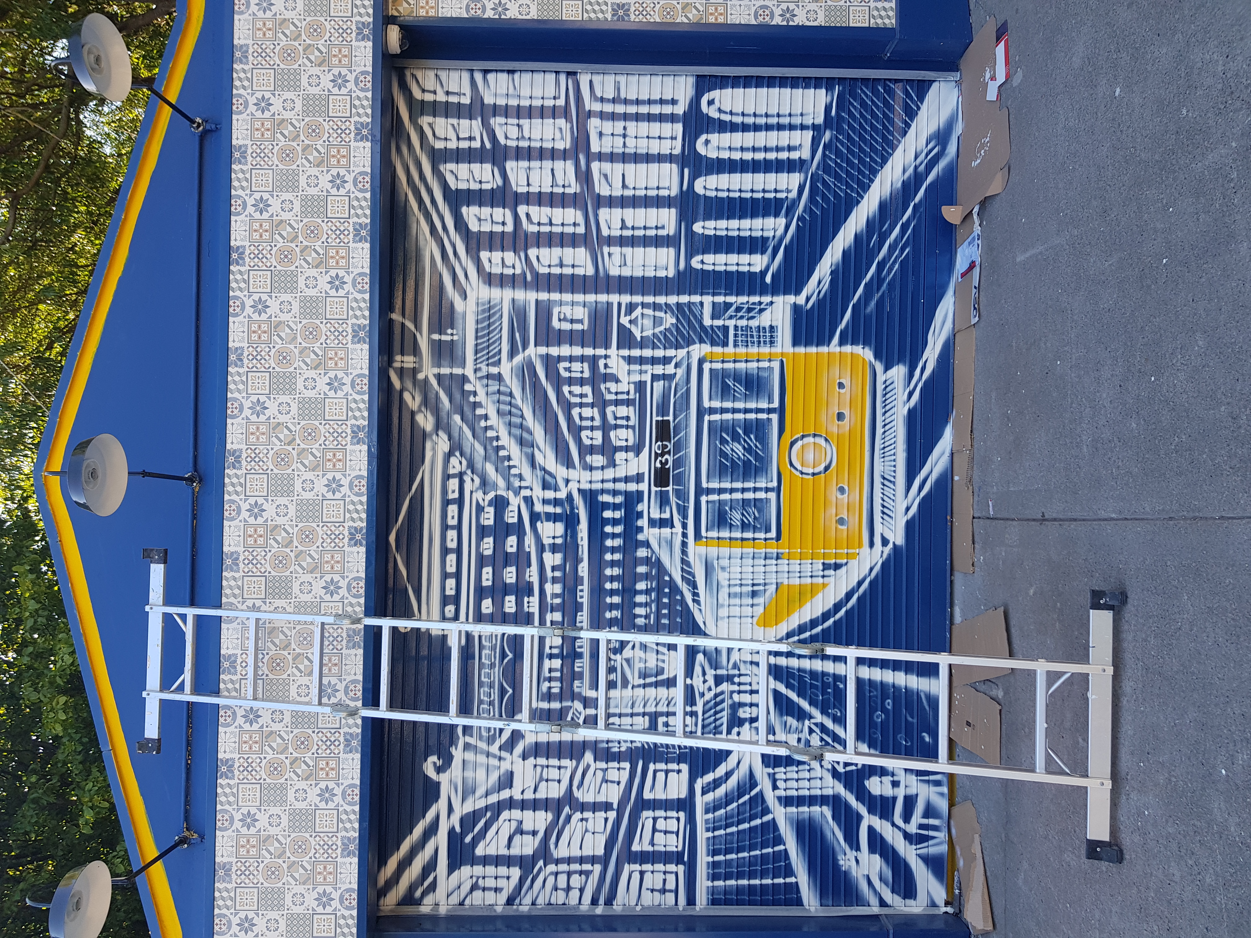 Portuguese tram scene painted on a restaurant wall in Dublin by ZAP Art mural artist Marcin Zapedowski